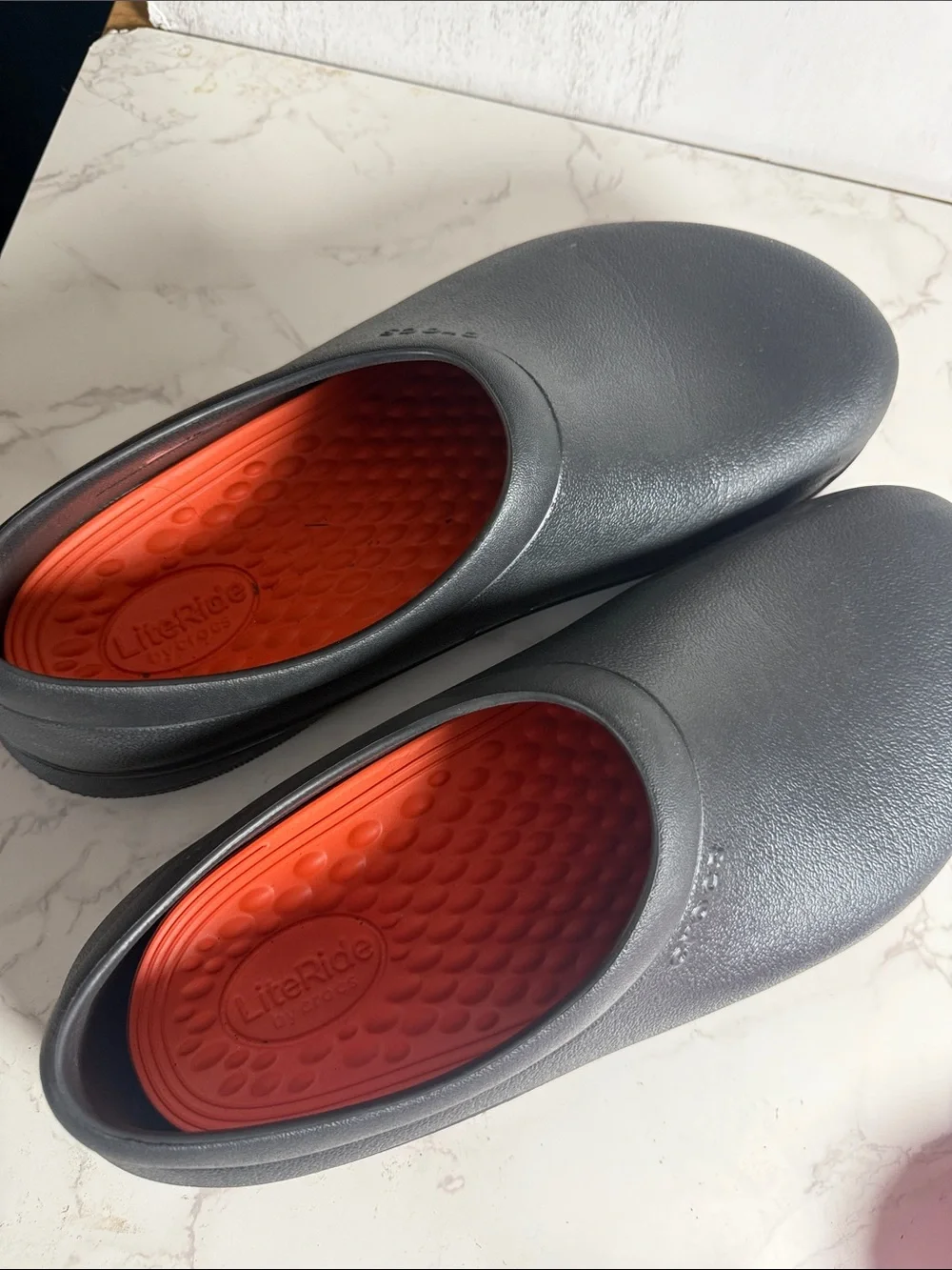 Two pairs of men’s size 11 crocs slides + black pair